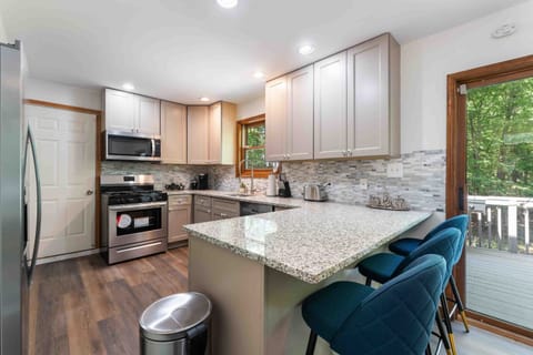 Casual bar seating at the kitchen counter — perfect for morning coffee or quick bites. - The Pasquin - East Stroudsburg, PA