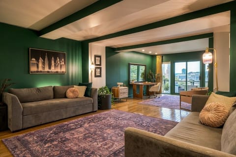 Grand in scale, intimate in feel. Our expansive living area wraps you in deep forest green, warm woods, and romantic, ambient lighting.