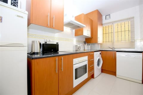 Kitchen in this apartment is fully equipped with all the appliances