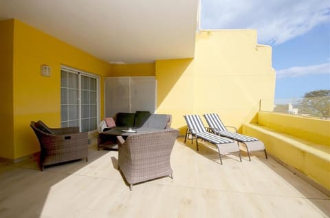 Large and sunny terrace with outdoor dining area, seating area and sun loungers