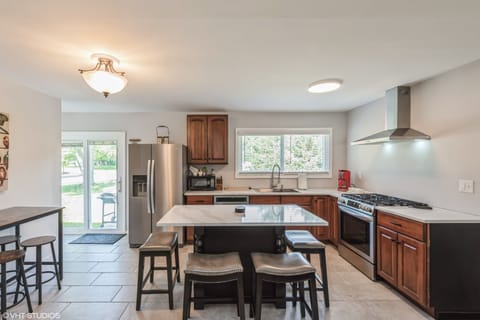 Kitchen with island seating for 4 people. There is also seating for 4 people along the side.