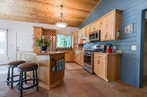 Spacious kitchen with newer stainless appliances including gas cooktop.