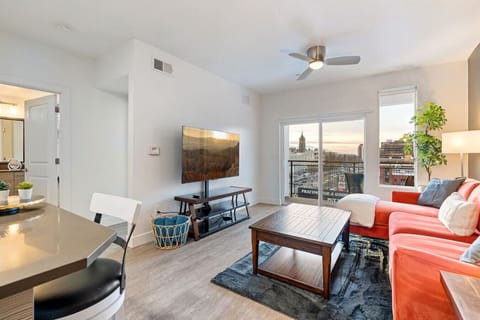 Gorgeous Livingroom, 65` TV, ComOpen plan kitchen/living room with large picture windows and  amazing viewsfy colorful couch. Beautiful views off your patio.