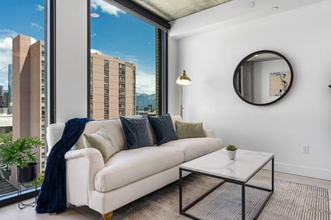 Luxury leather sofa and local art. Amazing views from the ceiling to floor windows and off the patio!A comfortable sofa is the cornerstone of a cozy living room.
