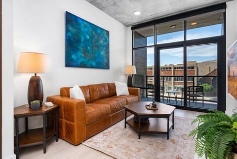 Beautifully designed living room. 65` TV, leather sofa and amazing views of mountains and city skyline.