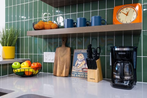 (1st Floor) Fully equipped kitchen with stainless steel appliances, basic cooking essentials, and kitchen island seating.