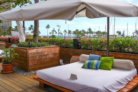 Lounge outdoors with ocean breezes and colorful tropical blooms.