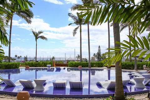 Escape into the stunning round pool under swaying palms.