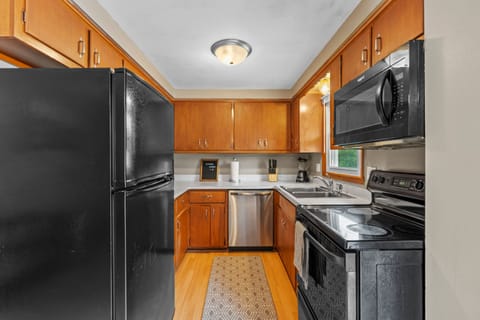 First floor kitchen with oven/range, full size refrigerator/freezer, dishwasher, and fully stocked with cookware, cutlery, glassware, etc.