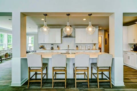 Large fully stocked kitchen with huge island, new stainless steel appliances, and large pantry.