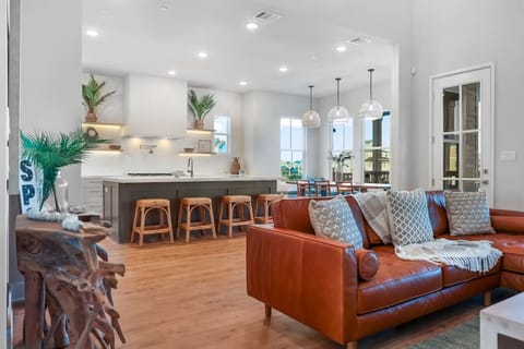 The main floor feels light and expansive with 20` ceilings, blending the living, dining, and kitchen into a seamless gathering space