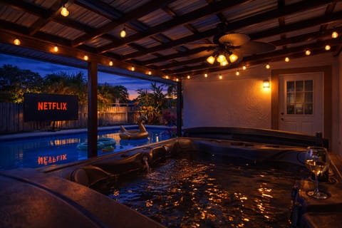 Unwind in the hot tub and watch your favorite TV shows/movies on the projector