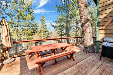 Relax on the scenic deck with a picnic table, BBQ, and peaceful views of surrounding trees and beautiful pine forest scenery.