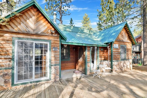 Welcoming cabin entry surrounded by towering pine trees, offering fresh mountain air and a peaceful forest setting—the perfect first impression for your Big Bear Lake getaway.