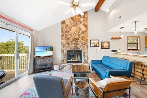 Cozy up by the fireplace in the inviting living room, with plenty of seating for all.