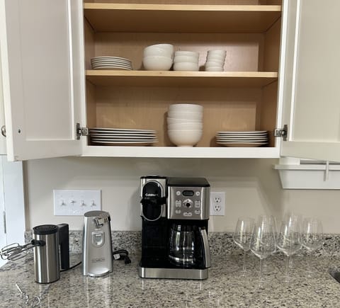 Coffee Pot & Pods, electric mixer & can opener, wine glasses, plates and bowles.