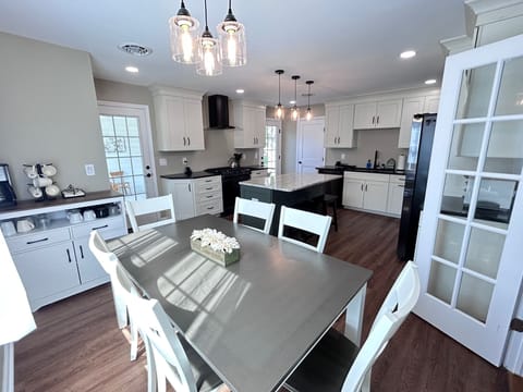 Eat-in and equiped kitchen with coffee bar, center island, upgraded appliances