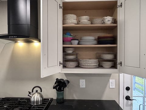 Plates, bowls, kids dishes, etc. Plus kettle and kitchen utensils.