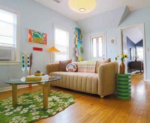 Living room has tons of natural light, a comfy couch, high-fi stereo system with a record player and tape deck. The space has a smart TV, air conditioning and a access to a small deck that overlooks the main strip.