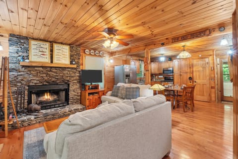 The living room has a wood-burning fireplace & flat screen TV. Seating for all guests as well.