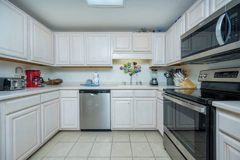 Prepare meals in this inviting kitchen featuring ample counter space and stainless appliances for your culinary adventures