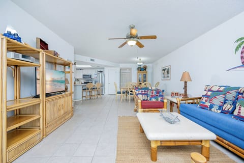 Relax in the inviting living area with colorful decor, sofa with queen sleeper, and easy access to dining and kitchen areas