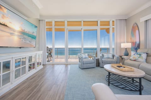 Gather in this welcoming living space and enjoy stunning panoramic beach views through the windows