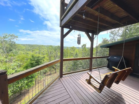 Back porch with swing, chimes, and a weber grill. Great spot to watch sunset!