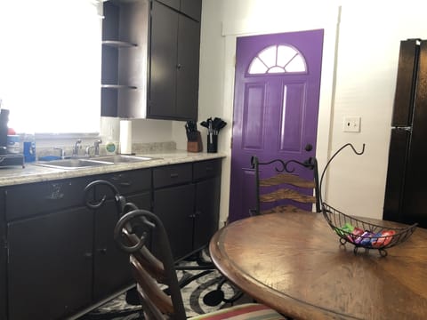 Fully stocked kitchen with dining table.