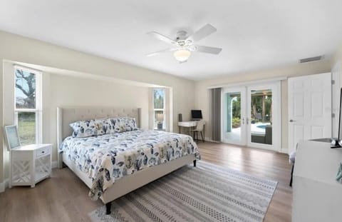 Master Bedroom with desk and chair with french doors to the patio