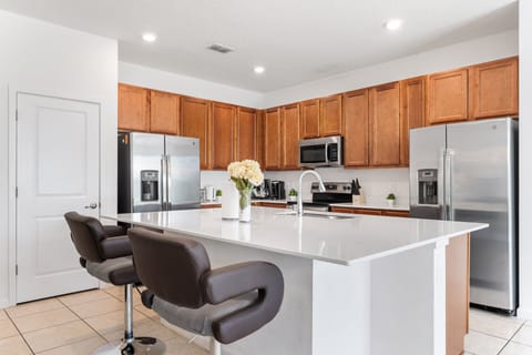 The kitchen is fully-equipped with stainless steel appliances.
