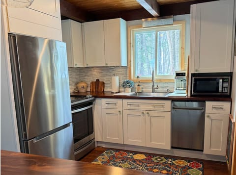 Full kitchen with dishwasher and ample counter space.
