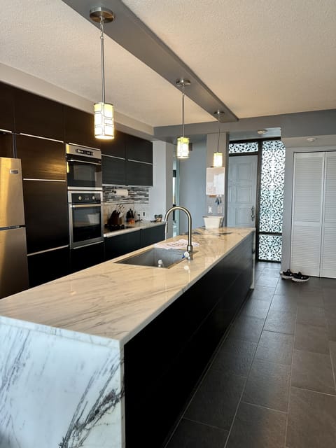 Gourmet kitchen/marble countertops, stainless appliances, wine fridge