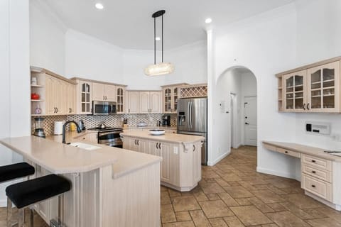 Fully stocked kitchen with center island, bar counter and work space