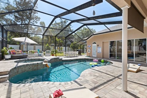 Heated saltwater pool & spa, outdoor lounges, and dining area