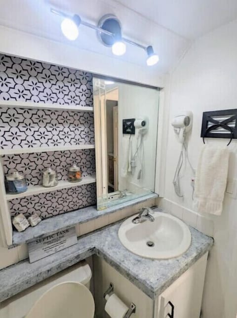 Bathroom is stocked with towels and toiletries 