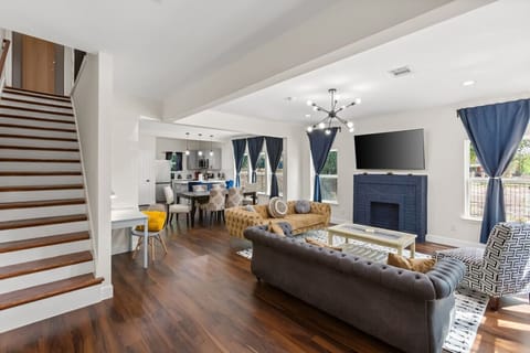 View of the downstairs living space with staircase leading to all three upstairs king bedrooms and full bathrooms.