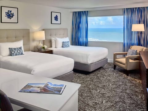 Lounge comfortably in a bright room with ocean scenery.
