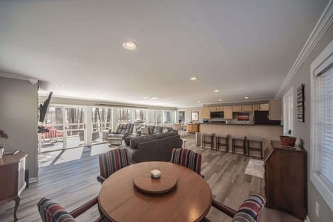 Flowing open space connecting living area, dining, and kitchen.