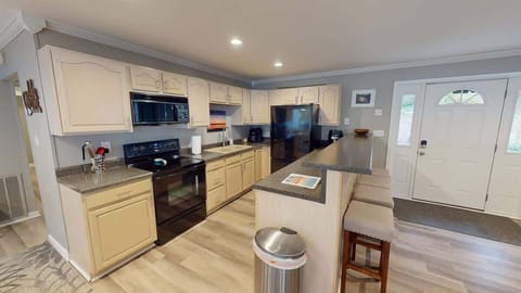 Spacious, functional kitchen with island seating for four guests.