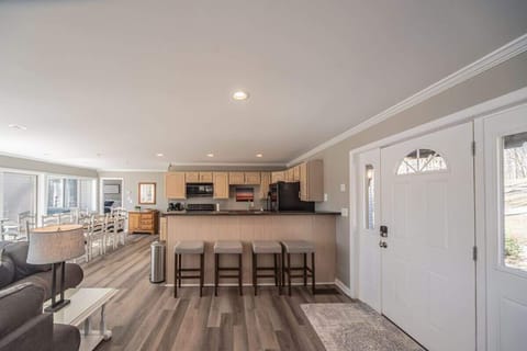 Kitchen, dining, and living merge in a bright open-concept space.