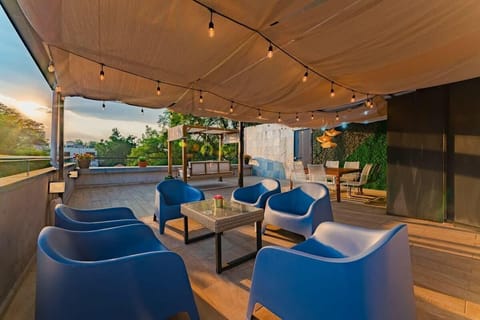 Relax on the rooftop terrace with comfy seating, cozy lights, and beautiful greenery.