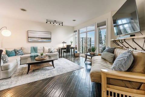 Space, Style, and Natural Light! This expansive open-concept living room is the ultimate gathering spot. Featuring a huge sectional sofa, a dedicated desk area, and a large Smart TV-all illuminated by stunning natural light from the patio doors