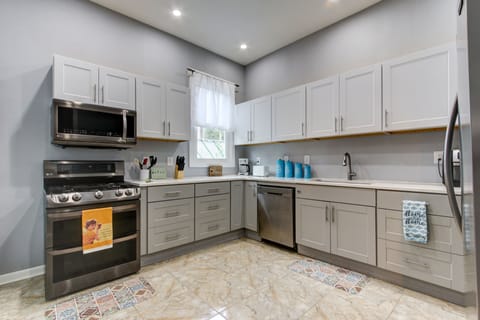 Fully stocked kitchen, with Gas stove, dishwasher, and large fridge.