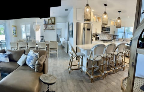 Open living space with 6 person seating at Island, 12 at table