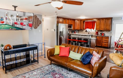 Make our living room the center of family moments, offering plush couches and a TV for delightful movie nights and bonding.