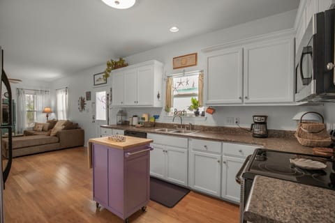 Kitchen is stocked with pots/pans/utensils.