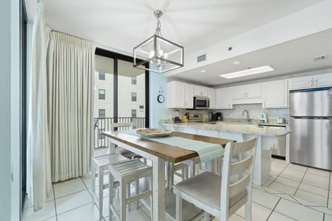 Dining table comfortably seats six with additional seating at kitchen bar.