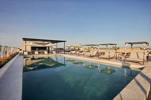 Dive into a spacious rooftop pool with stylish daybeds.