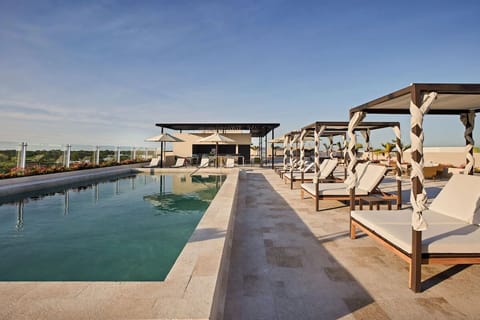 Stretch out in shaded cabanas and savor breezy rooftop views.